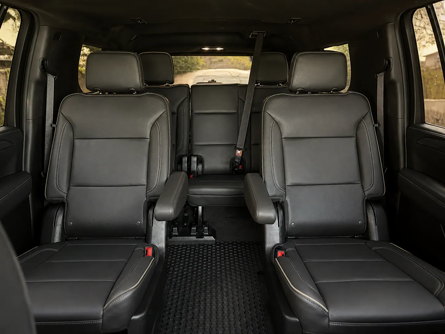 Spacious black full-size SUV cabin with captain's chairs for family transportation