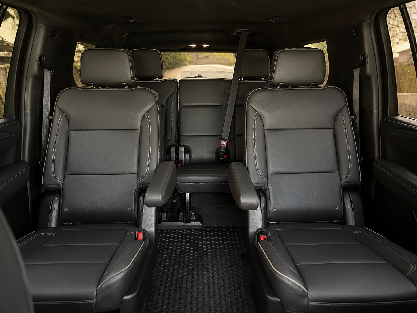 Spacious second-row captain chairs and third-row seating inside a real Gate & Mile Chevrolet Suburban