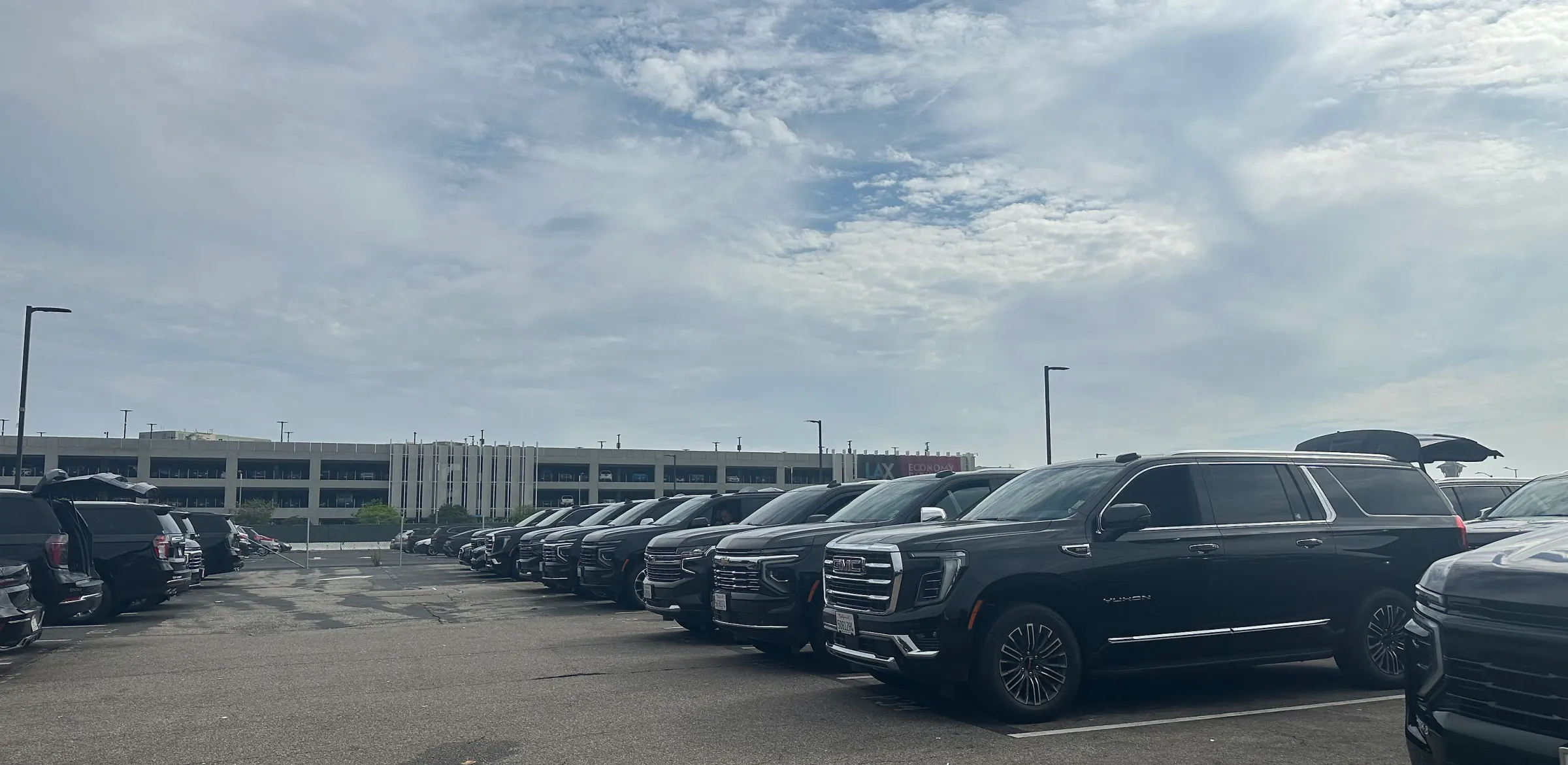 Gate and Mile black SUV fleet lined up at the LAX Economy Parking facility